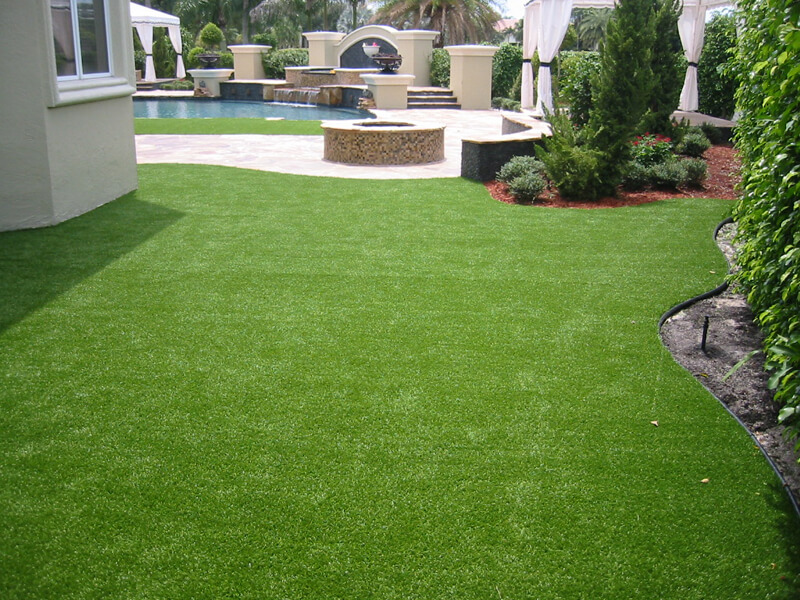 fake grass near firepit and pool
